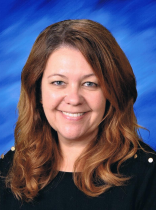 Headshot of white middle-aged woman with light brown hair just past her shoulders. She is smiling and looking at the camera.