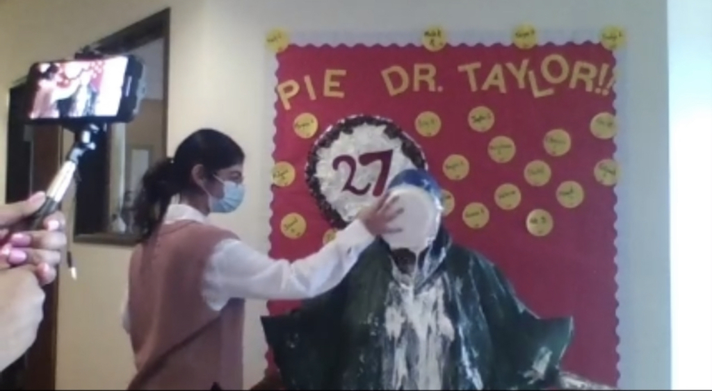 student and principal face pie