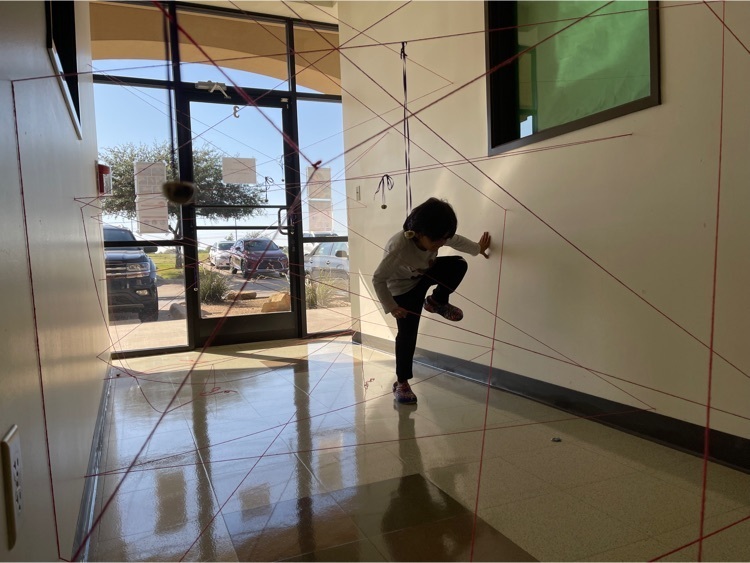 a young child goes through a yarn maze