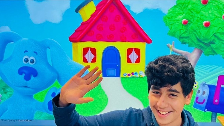 boy waving by cartoon house